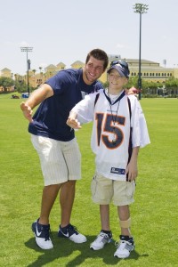 Tim Tebow and Adam Hubbs, 16, strike a Heisman pose at ESPN Wide World of Sports Complex