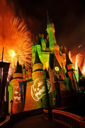 Orange fireworks explode over Cinderella Castle while illuminated pumpkins are projected with light during the "Happy HalloWishes" fireworks show. The show is part of "Mickey's Not-So-Scary Halloween Party," an after-hours Halloween celebration at the theme park. A separate ticket is required to attend. (Gene Duncan, photographer)